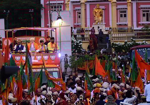 Prime Minister Narendra Modi wave at crowd during road show in heritage Mysuru city( Photo | EPS/ Udayashankar S)