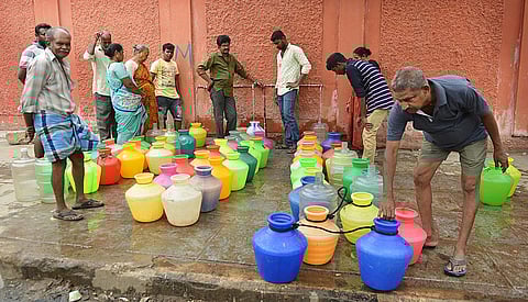 People in queue for water. (File | EPS)