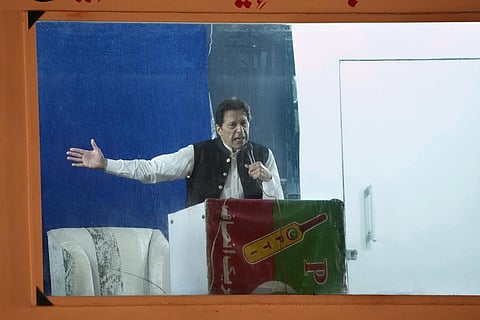 FILE - Protected by a bulletproof barrier, former Prime Minister Imran Khan speaks during a rally in Lahore, Pakistan, Sunday, March 26, 2023. (Photo | AP)