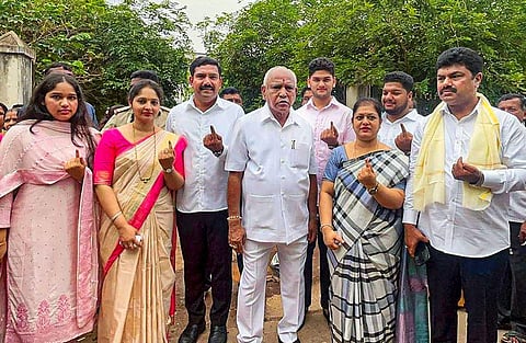 Former CM and senior BJP leader BS Yediyurappa with his family members after casting votes for Karnataka Assembly elections, in Shikaripura, Wednesday. (Photo | PTI)