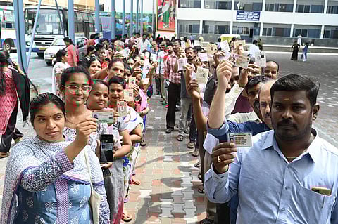 People wait in queues at a polling station to cast their votes for Karnataka Assembly elections, in Bengaluru. (Photo | Nagaraja Gadekal, EPS)