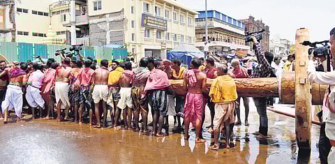 Biswakarma servitors fixing wheels to a chariot axle in Puri on Friday | Express