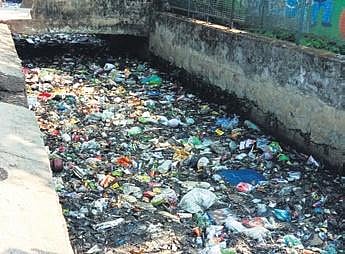 A drain passing through Jhola Sahi choked with silt, garbage and waste material