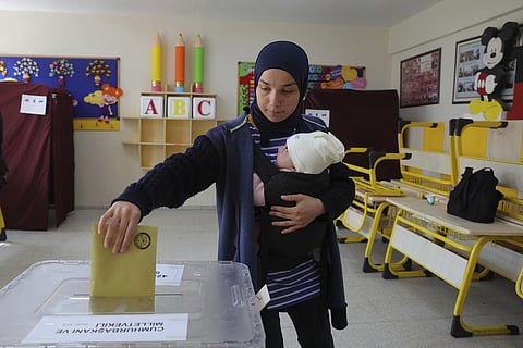 Image used for representational purpose. A woman with a baby votes at a polling station in Ankara. (Photo | AP)