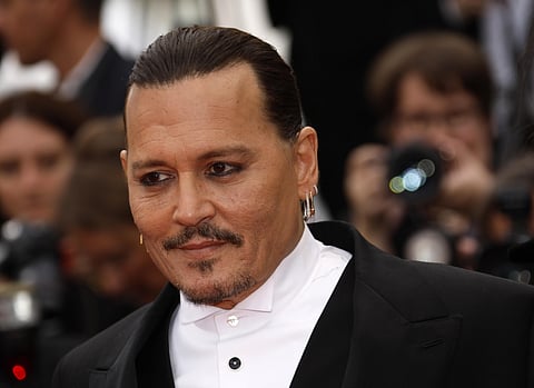 Johnny Depp was feted by fans on Tuesday as he arrived on the red carpet for the screening of his comeback movie at the opening of the Cannes Film Festival, which has sparked anger over the choice to celebrate the divisive megastar. (Photo | AP)