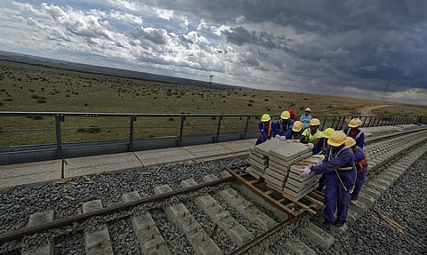 Kenyan laborers work to finish the construction of an existing bridge that goes across a corner of Nairobi National Park in Nairobi as part of a Chinese-built railway project (Photo | AP)