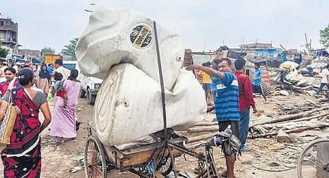 Locals shift their belongings as illegal constructions are demolished during an antiencroachment drive near the Tughlaqabad Fort. (Photo | PTI)