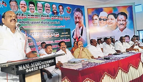 Two leaves symbol and the AIADMK flag are seen on the poster at the function hosted by O Pannerselvam at Bhavani in Erode district | Express