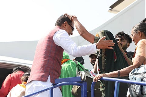 Madhya Pradesh Chief Minister Shivraj Singh Chouhan greets senior citizens leaving for Prayagraj by air on free pilgrimage under MP govt scheme, in Bhopal, May 21, 2023. (Photo | PTI)