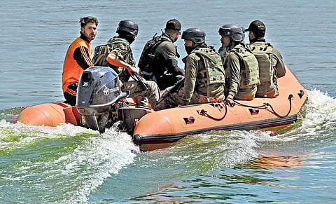Indian paramilitary troopers patrol in Dal Lake in Srinagar on Sunday. (Photo | PTI)