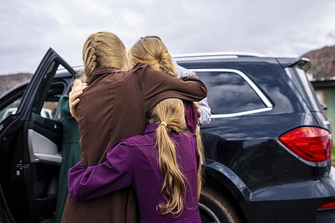 FILE - Three girls embrace before they are removed from the home of Samuel Bateman, following his arrest in Colorado City, Ariz., on  Sept. 14, 2022. (Photo | AP)