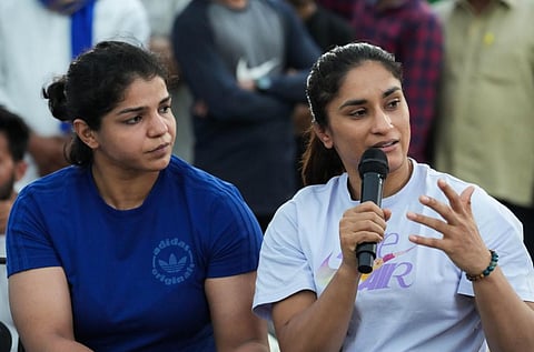 Protesting wrestlers Vinesh Phogat (R) and Sakshi Malik during a press conference, at Jantar Mantar in New Delhi. (Photo | PTI)