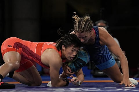 Risako Kawai, left, and United States Helen Louise Maroulis compete during the women's 57kg Freestyle semifinal wrestling match at the 2020 Summer Olympics, Aug. 4, 2021, in  Japan. (File Photo | AP)