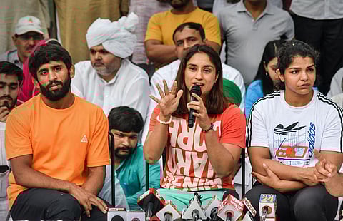 Wrestlers Bajrang Punia, Vinesh Phogat and Sakshi Malik addressing the media. (Photo | PTI)