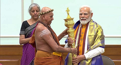 Prime Minister Narendra Modi receives 'Sengol' from an Adheenam on eve of new Parliament building inauguration, in New Delhi. (Photo | PTI)