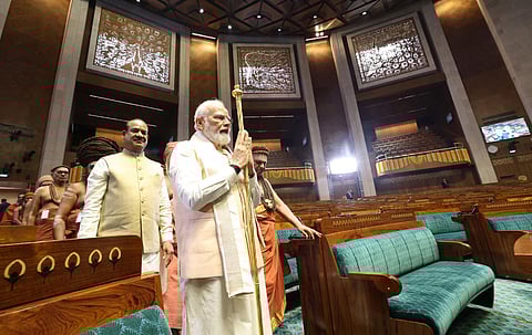 PM Modi carries the 'Sengol' before installing it in the Lok Sabha chamber at the inauguration of the new Parliament building, in New Delhi, May 28, 2023. (Photo | PTI)