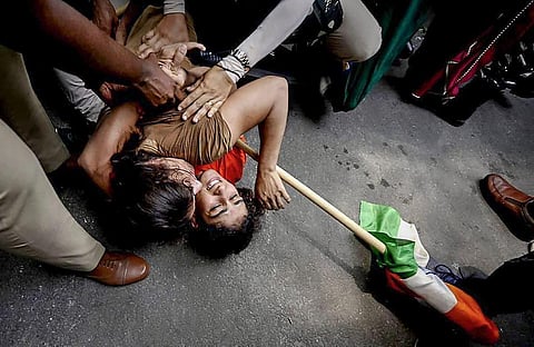 Security personnel detain wrestlers Vinesh Phogat and Sangeeta Phogat during wrestlers' protest march towards new Parliament building, in New Delhi, Sunday, May 28, 2023. (Photo | PTI)