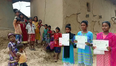 The four girls who passed their Class 10 board exams display their score card. (Photo | Special Arrangement)