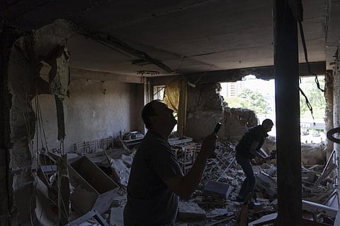 Men inspect their office damaged by a drone during a night attack, in Kyiv, Ukraine, Sunday, May 28, 2023.  (Photo | AP)