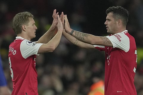 Arsenal's Martin Odegaard, left, and Arsenal's Granit Xhaka celebrate after the English Premier League soccer match between Arsenal and Chelsea at the Emirates Stadium in London. (Photo | AP)