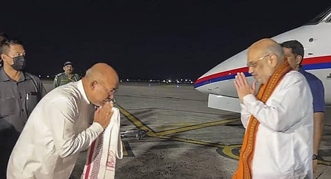 Union Home Minister Amit Shah being received by Manipur CM N. Biren Singh upon his arrival in Imphal. (Photo | PTI)