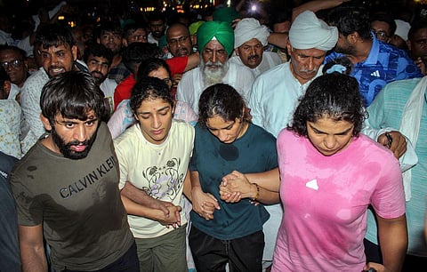 Protesting wrestlers Bajrang Punia, Sakshi Malik, Vinesh Phogat and Sangeeta Phogat at Har ki Pauri ghat, in Haridwar on Tuesday. (Photo | PTI)