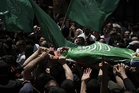 Palestinians carry the body of Hassan Qatnani, draped in the Hamas militant group flag, during his funeral in the West Bank city of Nablus on Thursday, May 4, 2023. (Photo | AP)