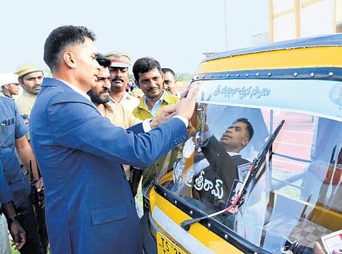 Rajanna-Sircilla district SP Akhil Mahajan pastes a QR code on an autorickshaw