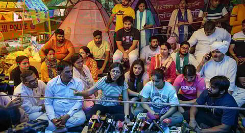 DCW Chairperson Swati Maliwal speaks with the media as wrestlers Vinesh Phogat, Bajrang Punia, Sakshi Malik and Sangeeta Phogat look on during the wrestlers' protest at Jantar Mantar. (Photo | PTI)