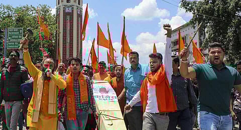 Bajrang Dal workers stage a protest against Congress' manifesto for Karnataka elections, in Dehradun. (Photo | PTI)