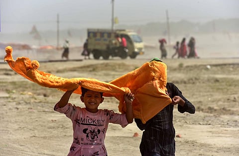 Children use a cloth to shield themselves from the scorching heat on a hot summer day. Image used for representational purpose. (Photo | PTI)