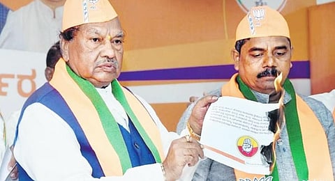 BJP MLA KS Eshwarappa burns a copy of the Congress manifesto in Kalaburagi  on Thursday | Express