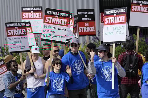Striking writers rally in front of Netflix offices, Wednesday, May 3, 2023, in Los Angeles.