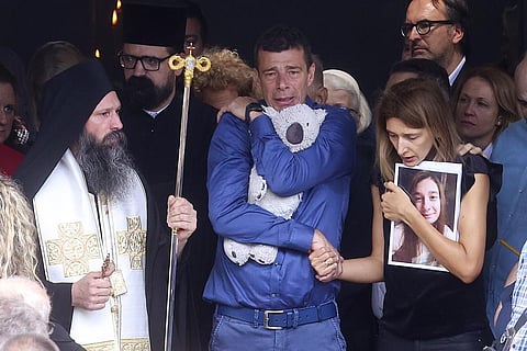 Parents of Ema Kobiljski, 13, mourn during the funeral procession at the central cemetery in Belgrade, Serbia, Saturday, May 6, 2023. (Photo | AP)