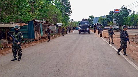 Army and Assam Rifles personnel in violence-hit areas across Manipur.