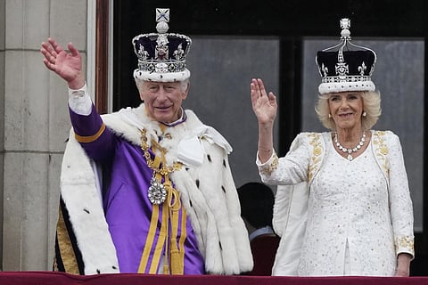 Britain's King Charles III and Queen Camilla wave to the crowds from the balcony of Buckingham Palace after the coronation ceremony in London on May 6, 2023. (Photo | AP)