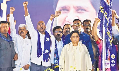BSP State president RS Praveen Kumar and other leaders raise slogans as party chief Mayawati looks on during a public meeting in Hyderabad on Sunday