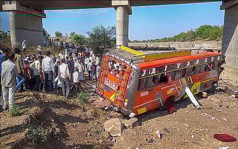 Locals gather at the site after a bus fell from a bridge in Madhya Pradesh's Khargone district, Tuesday, May 9, 2023. (Photo | PTI)