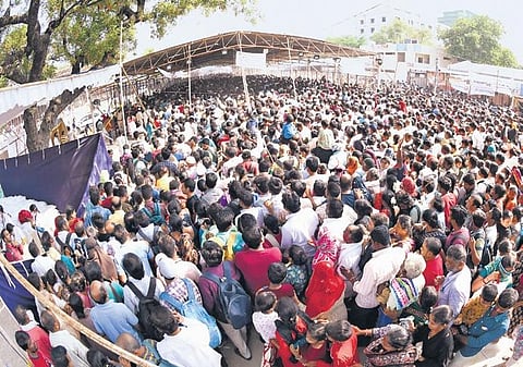 Thousands of people wait to receive fish prasadam in Hyderabad on Friday