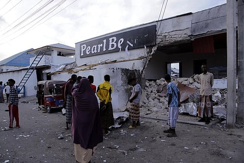Somalis stand stand outside the destroyed Pearl Beach hotel in Mogadishu, Somalia, Saturday, June 10, 2023. (Photo | AP)