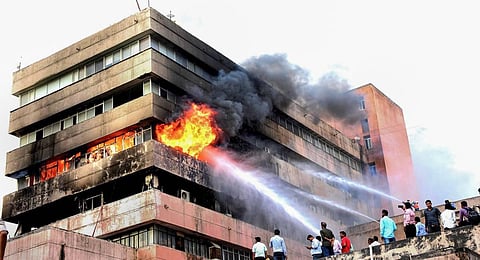 Firemen douse fire that broke out on the third floor of Satpura Bhawan, a building housing offices of various departments of the Madhya Pradesh government, in Bhopal. (Photo | PTI)