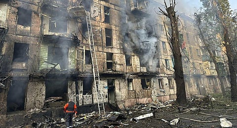 Emergency workers extinguish a fire after missiles hit a multi-story apartment building in Kryvyi Rih, Ukraine. (Photo | AP)