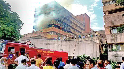 Firemen douse the fire in Satpura Bhawan in Bhopal on Monday . (Photo  | PTI)