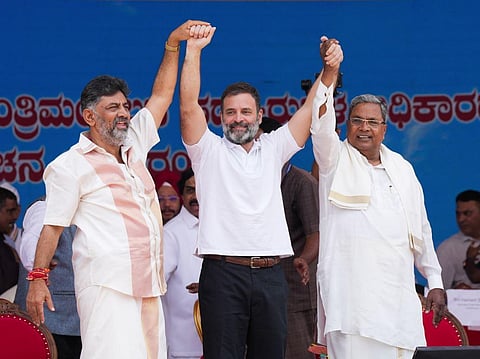 Congress leader Rahul Gandhi with Karnataka CM-designate and Dy CM-designate Siddaramaiah and DK Shivakuamr during their oath ceremony in Bengaluru, May 20, 2023. (Photo | PTI)