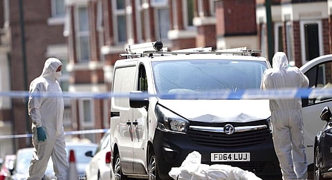 Police forensics officers search a white van on the corner of Maples Street and Bentinck Road in Nottingham, as three people have been found dead in the city. (Photo | AP)
