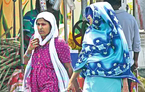 People covering their faces with scarves to protect from heat I Prasant Madugula