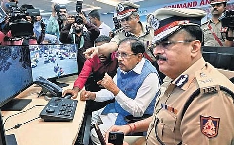 Home Minister G Parameshwara inspects CCTV footage during his visit to the office of the City Police Commissioner on Friday. 