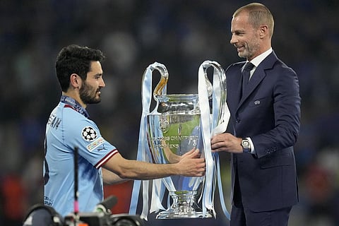 UEFA president Aleksander Ceferin hands the trophy to Manchester City's team captain Ilkay Gundogan after they won the Champions League final soccer match. (Photo | AP)
