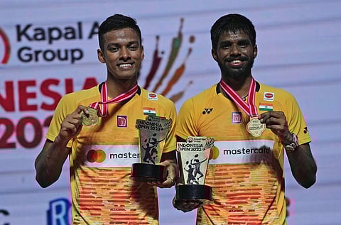 India's Satwiksairaj Rankireddy, right, and Chirag Shetty celebrate with their medals and trophies after their victory. (Photo | PTI)