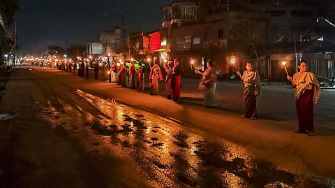 Women form a human chain to protest against the ethnic violence between the Meitei and Kuki community in Manipur. 